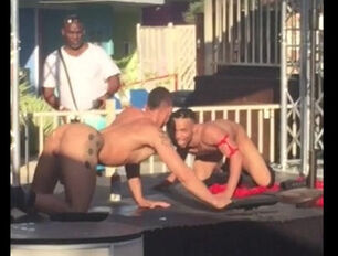 2 queer strippers smooch and gobble each other at outdoor
