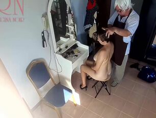 Camera In Bare Barbershop. Hairdresser Makes Unclothe Nymph