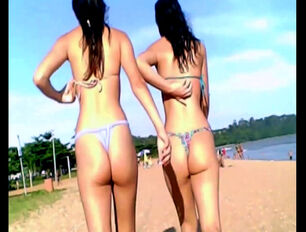 2 suntanned dark haired young ladies in panty bathing suit